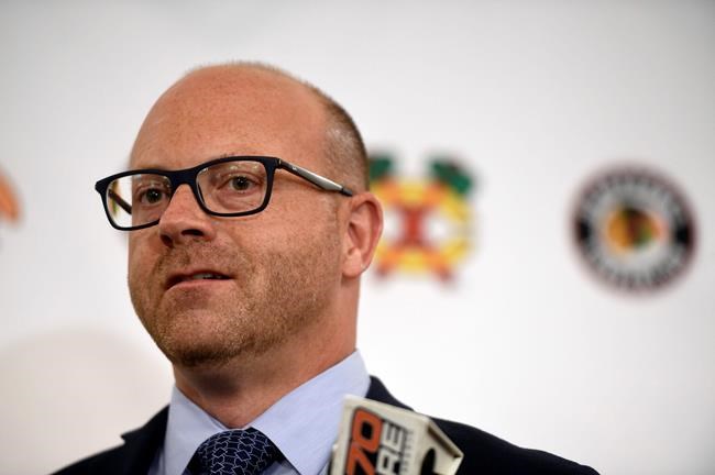 FILE - In this July 27, 2018, file photo, Chicago Blackhawks general manager Stan Bowman speaks to the media during the NHL hockey team's convention in Chicago Bowman has plenty of work to do as he tries to get the Blackhawks back to where they were a few years ago, when they won three Stanley Cups in six years. The Blackhawks gave him a neat new title this week, elevating him to president of hockey operations as part of a front office makeover. (AP Photo/Annie Rice, File)