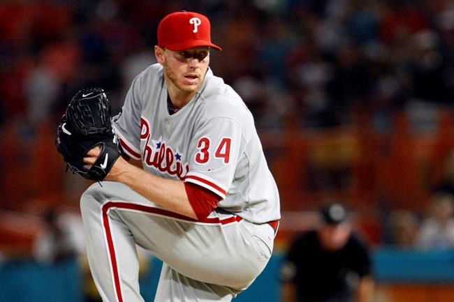 FILE - In this May 29, 2010, file photo, Philadelphia Phillies starting pitcher Roy Halladay throws a pitch in the ninth inning of a baseball game against the Florida Marlins in Miami. The Phillies will retire the late Hall of Fame pitcher's No. 34 this season. The Phillies will pay tribute to Halladay on May 29, 2020, the 10th anniversary of his perfect game against the Marlins. Halladay was 40 when he was killed in a plane crash in November 2017. (AP Photo/Wilfredo Lee, File)