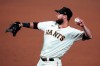FILE- In this Sept. 22, 2020, file photo, San Francisco Giants' Brandon Belt throws the ball during a baseball game against the Colorado Rockies in San Francisco. Belt got hit with quite a double-whammy that derailed his offseason: First, in January, he contracted the coronavirus only to immediately become ill again with mononucleosis. Gradually regaining his strength and stamina at last, the first baseman acknowledges he isn't sure he will be ready for opening day with the San Francisco Giants. (AP Photo/Jeff Chiu, File)
