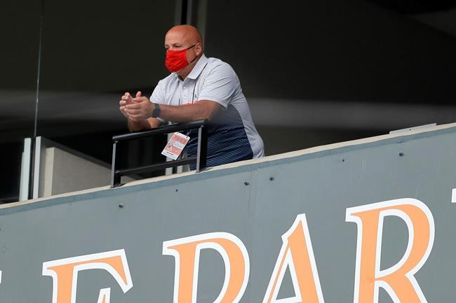 FILE - In this Aug. 14, 2020, file photo, Washington Nationals general manager Mike Rizzo looks on during the seventh inning in the continuation of a suspended baseball game between the Baltimore Orioles and the Nationals in Baltimore. The Nationals and Rizzo finalized a multiyear contract extension Saturday, Sept. 5, 2020. The 59-year-old Rizzo, who also holds the title of president of baseball operations, built the team that won the 2019 World Series championship. (AP Photo/Julio Cortez, File)