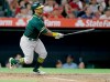 FILE - In this Sept. 24, 2019, file photo, Oakland Athletics designated hitter Khris Davis watches his his two-run home run against the Los Angeles Angels during the fourth inning of a baseball game in Anaheim, Calif. The Texas Rangers traded Elvis Andrus to the Oakland Athletics on Saturday, Feb. 6, 2021. Texas is sending the 32-year-old Andrus, catcher Aramis Garcia and $13.5 million to the A's for designated hitter Khris Davis, along with catcher Jonah Heim and right-hander Dane Acker. (AP Photo/Alex Gallardo, File)