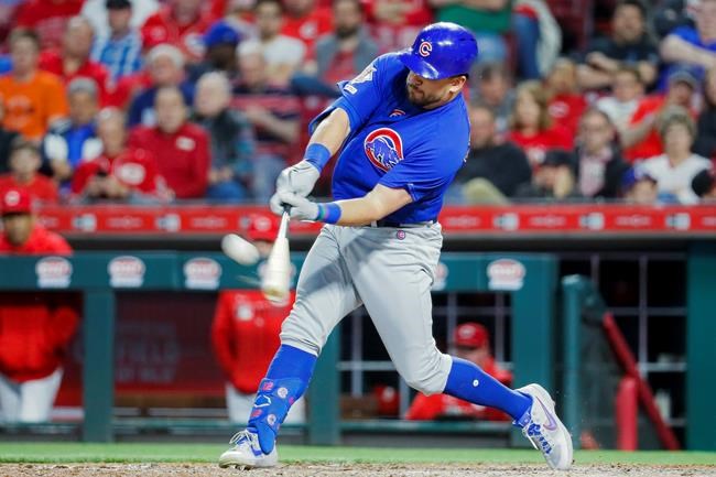 FILE - In this May 15, 2019, file photo, Chicago Cubs' Kyle Schwarber hits a solo home run off Cincinnati Reds relief pitcher David Hernandez in the eighth inning of a baseball game in Cincinnati. Schwarber agreed in principle to a one-year, $10 million contract with the Washington Nationals, according to a person familiar with the deal. The person confirmed the agreement to The Associated Press on condition of anonymity on Saturday, Jan. 9, 2021, because a physical exam was still pending for Schwarber. (AP Photo/John Minchillo, File)