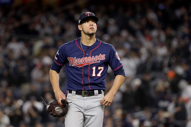FILE - In this Oct. 4, 2019, file photo, Minnesota Twins starting pitcher Jose Berrios (17) reacts as he walks off the field at the end of the third inning against the New York Yankees during Game 1 of an American League Division Series baseball game in New York. The Twins beat Berríos in salary arbitration giving teams a 2-0 record in hearings this year. Berríos will be paid $4,025,000 rather than his request for $4.4 million. The decision was made Thursday, Feb. 6, 2020, by Frederic Horowitz, Andrew Strongin and Margaret Brogan, who heard the case a day earlier. (AP Photo/Frank Franklin II, File)