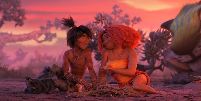 This image released by DreamWorks shows Guy, voiced by Ryan Reynolds, left, and Eep Crood, voiced by Emma Stone, in a scene from the animated film