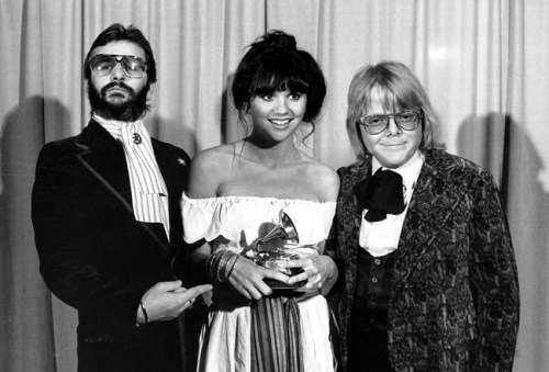 FILE - This Feb. 20, 1977 file photo shows singer Linda Ronstadt is flanked by Ringo Starr, left, and Paul Williams after she was named best pop singer for her 