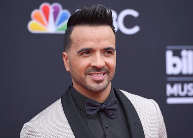 FILE - In this May 20, 2018 file photo, Luis Fonsi arrives at the Billboard Music Awards in Las Vegas. Telemundo is offering a first-of-its-kind virtual music special on Spanish-language media, featuring stars such as J Balvin, Luis Fonsi, Alejandro Sanz and Gloria Estefan.“Concierto en Casa” will air Saturday at 7 p.m. Eastern on Telemundo Network, UNIVERSO and across all its platforms. (Photo by Jordan Strauss/Invision/AP, File)