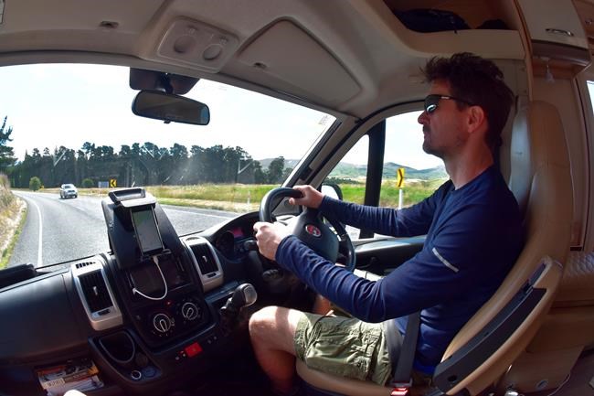 This Dec. 22, 2019, photo taken with a fisheye lens shows Malcolm Foster driving a rented camper van on the South Island of New Zealand. Touring in a camper van is a popular way for tourists to see the country. (Jacob Foster via AP)