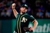 FILE - In this Sept. 14, 2019, file photo, Oakland Athletics relief pitcher Liam Hendriks works against the Texas Rangers during a baseball game in Arlington, Texas. Hendriks had to help somehow when fires ravaged his homeland in Australia this winter. He briefly got home to Perth but mostly campaigned on social media from a world away to generate awareness and support for Red Cross Australia. (AP Photo/Tony Gutierrez, File)
