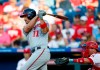 FILE - In this July 12, 2019, file photo, Washington Nationals' Ryan Zimmerman, left, follows through after hitting an RBI-sacrifice fly off Philadelphia Phillies starting pitcher Nick Pivetta during the third inning of a baseball game in Philadelphia. Like all major leaguers, Zimmerman finds himself with a lot more time on his hands than usual this spring because baseball is on hold during the coronavirus pandemic. He occasionally will be offering his thoughts to The Associated Press in a diary of sorts while waiting for the 2020 season to begin. (AP Photo/Matt Slocum, File)
