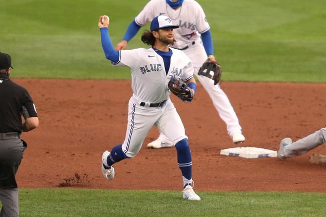 Toronto Blue Jays shortstop Bo Bichette throws to first for the out after fielding a ball hit by Tampa Bay Rays' Yandy Diaz during the third inning of a baseball game Saturday, Aug. 15, 2020, in Buffalo, N.Y. (AP Photo/Jeffrey T. Barnes)