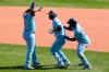 Toronto Blue Jays' Lourdes Gurriel Jr., center, along with teammates Vladimir Guerrero Jr. and Teoscar Hernandez, celebrates his game-winning walk off RBI single to beat the Philadelphia Phillies 3-2 during the seventh inning of the first baseball game of a doubleheader, Thursday, Aug. 20, 2020, in Buffalo, N.Y. (AP Photo/Jeffrey T. Barnes)