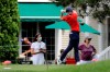 People are seen in the backyard of a home as Rory McIlroy, of Northern Ireland, tees off on the sixth hole during the final round of the Travelers Championship golf tournament at TPC River Highlands, Sunday, June 28, 2020, in Cromwell, Conn. (AP Photo/Frank Franklin II)