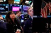 FILE - In this Feb. 24, 2020, file photo specialist Erica Fredrickson works with a colleague on the floor of the New York Stock Exchange. The U.S. stock market opens at 9:30 a.m. EST on Tuesday, Feb. 25. (AP Photo/Richard Drew, File)