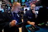 FILE - In this Dec. 11, 2019, file photo trader Michael Urkonis, left, and specialist Anthony Matesic work on the floor of the New York Stock Exchange. The U.S. stock market opens at 9:30 a.m. EST on Friday, Jan. 3, 2020. (AP Photo/Richard Drew, File)
