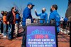 Fans arrive for COVID-19 screenings before entering Citifield before New York Mets home opening baseball game against the Miami Marlins, Thursday, April 8, 2021, in New York. (AP Photo/John Minchillo)