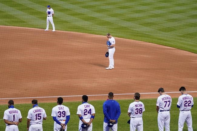 The New York Mets and the Miami Marlins stand on the field and bow their heads at the start of their baseball game before walking off in protest, Thursday, Aug. 27, 2020, in New York. The teams jointly walked off the field after a moment of silence, draping a Black Lives Matter T-shirt across home plate as they chose not to start their scheduled game Thursday night. (AP Photo/John Minchillo)(AP Photo/John Minchillo)