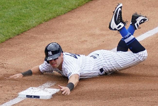 New York Yankees' Mike Tauchman advances to third on a missed pick-off attempt at first by New York Mets starting pitcher Robert Gsellman in the fourth inning of a baseball game, Saturday, Aug. 29, 2020, in New York. (AP Photo/John Minchillo)