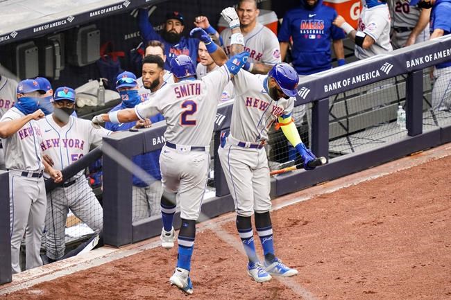 New York Mets' Dominic Smith (2) celebrates with Amed Rosario (1) after hitting a go-ahead solo home run off New York Yankees relief pitcher Chad Green in the sixth inning of the first baseball game of a doubleheader, Friday, Aug. 28, 2020, in New York. (AP Photo/John Minchillo)