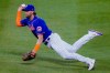 New York Mets second baseman Jeff McNeil slips as he fields a single hit by Miami Marlins' Lewis Brinson during the seventh inning in the first baseball game of a doubleheader, Tuesday, Aug. 25, 2020, in New York. (AP Photo/John Minchillo)