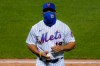New York Mets manager Luis Rojas walks back to the dugout after relieving relief pitcher Justin Wilson in the eighth inning of a baseball game against the Miami Marlins, Wednesday, Aug. 26, 2020, in New York. (AP Photo/John Minchillo)