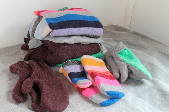 This Feb. 4, 2020 photo taken in Hopkinton, N.H., shows three pairs of handmade mittens, each constructed from sweaters using slightly different techniques. If winter is lasting longer than the groundhog predicted where you live, consider restocking your mitten supply and clearing out your closet at the same time. Instead of tossing stained or accidentally shrunken sweaters, turn them into cozy mittens. (AP Photo/Holly Ramer)