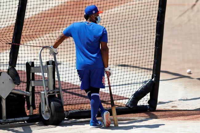 New York Mets' Robinson Cano leans on his bat as he waits his turn in the cage during baseball practice at Citi Field, Thursday, July 16, 2020, in New York. (AP Photo/Kathy Willens)