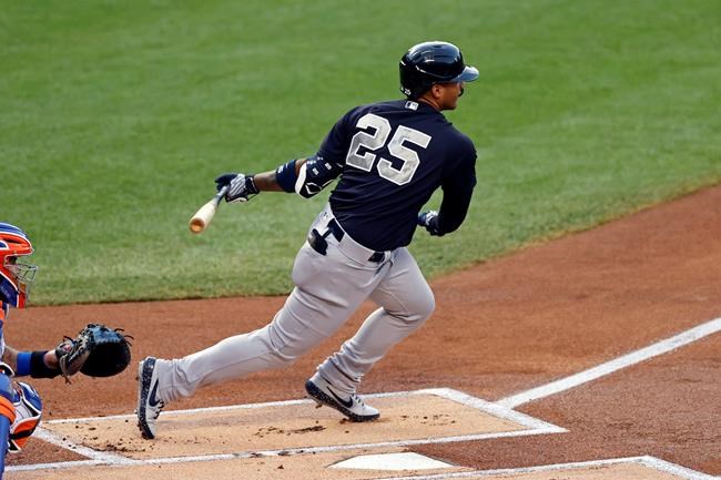 New York Yankees Gleyber Torres (25) hits an RBI single against the New York Mets during the first inning of a baseball spring training game Saturday, July 18, 2020, in New York. (AP Photo/Adam Hunger)