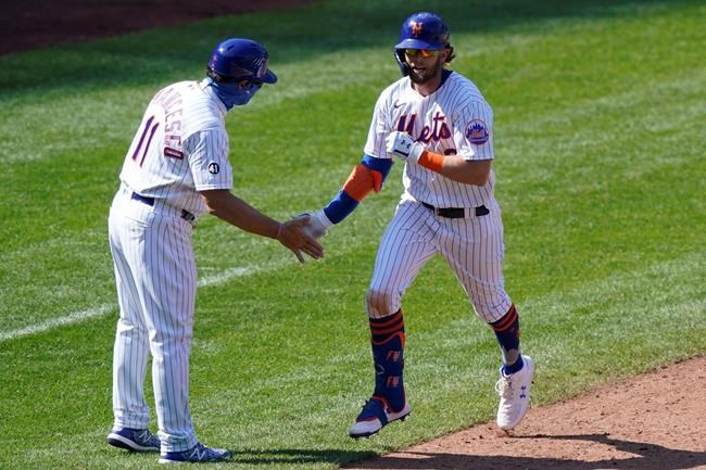 New York Mets third base coach Tony DeFrancesco congratulates Jeff McNeil (6) as McNeil trots the bases after hitting a solo home run during the sixth inning of a baseball game against the Philadelphia Phillies, Sunday, Sept. 6, 2020, in New York. (AP Photo/Kathy Willens)