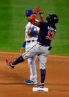 Atlanta Braves' Ronald Acuna Jr. (13) celebrates after hitting a double in front of New York Mets second baseman Robinson Cano during the first inning of a baseball game on Friday, Sept. 18, 2020, in New York. (AP Photo/Adam Hunger)