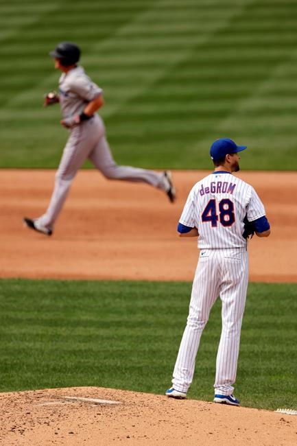 New York Mets pitcher Jacob deGrom (48) reacts after giving up a solo home run to Miami Marlins' Garrett Cooper as Cooper rounds ther bases during the sixth inning of a baseball game on Monday, Aug. 31, 2020, in New York. (AP Photo/Adam Hunger)