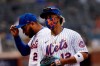 New York Mets' Francisco Lindor, right, and Dominic Smith return to the dugout during the seventh inning of a baseball game against the Washington Nationals, Saturday, April 24, 2021, in New York. (AP Photo/Jason DeCrow)