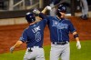 Tampa Bay Rays' Brandon Lowe, left, celebrates with teammate Yoshitomo Tsutsugo, of Japan, after they scored on a two-run home run by Lowe during the eighth inning of a baseball game against the New York Mets Wednesday, Sept. 23, 2020, in New York. (AP Photo/Frank Franklin II)