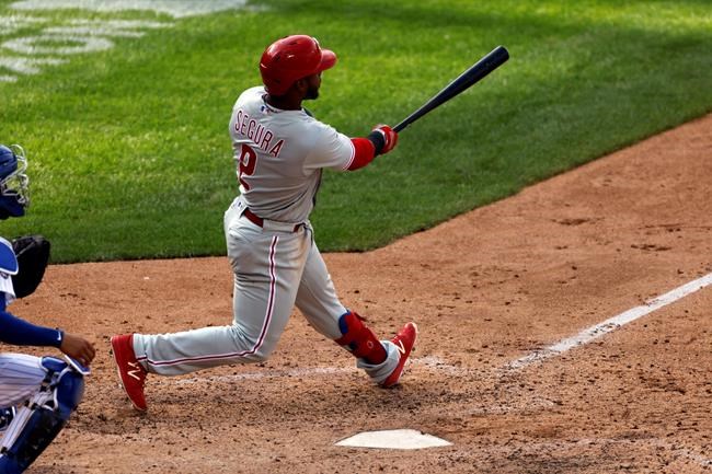 Philadelphia Phillies' Jean Segura hits a two-run home run during the 10th inning of a baseball game against the New York Mets on Monday, Sept. 7, 2020, in New York. (AP Photo/Adam Hunger)