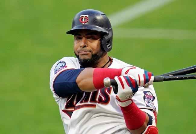FILE - In this Monday, Aug. 31 2020 file photo, Minnesota Twins designated hitter Nelson Cruz (23)} waits to bat against the Chicago White Sox in a baseball game in Minneapolis. Minnesota Twins manager Rocco Baldelli has made no secret of the team's desire to re-sign designated hitter Nelson Cruz. Baldelli took his interest in the 40-year-old free agent a step further by taking a few seconds out of his video conference call with reporters to make a pretend pitch to the six-time All-Star. Cruz has batted .308 with 57 home runs, 141 RBIs and a 1.020 on-base-plus-slugging percentage in 173 games with the Twins. He's been their best hitter over Baldelli's two seasons and a significant reason why they’ve won the AL Central both years. (AP Photo/Jim Mone, File)