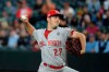 FILE - In this Sept. 10, 2019, file photo, Cincinnati Reds starting pitcher Trevor Bauer throws to a Seattle Mariners batter during the first inning of a baseball game in Seattle. Trevor Bauer is coming home to pitch for the World Series champion Los Angeles Dodgers. The reigning NL Cy Young Award winner was introduced Thursday, Feb. 11, 2021 on the field at Dodger Stadium. (AP Photo/Ted S. Warren, File)