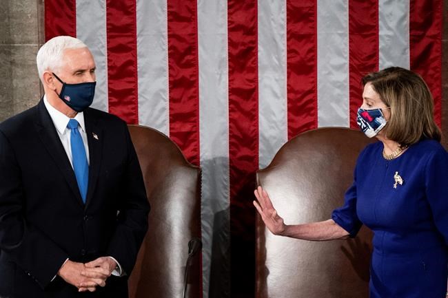 Speaker of the House Nancy Pelosi, D-Calif., and Vice President Mike Pence officiate as a joint session of the House and Senate convenes to confirm the Electoral College votes cast in November's election, at the Capitol in Washington, Wednesday, Jan. 6, 2021. (Erin Schaff/The New York Times via AP, Pool)