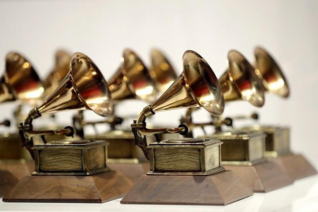 FILE - In this Oct. 10, 2017, file photo, various Grammy Awards are displayed at the Grammy Museum Experience at Prudential Center in Newark, N.J. The Recording Academy is partnering with Berklee College of Music and Arizona State University to complete a study focused on women's representation in the music industry.. The academy, which puts on the annual Grammy Awards, said the lack of female creators in music is “one of the most urgent issues in the industry today.