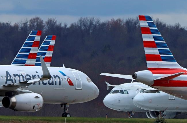FILE - In this March 31, 2020 file photo American Airlines planes are parked at Pittsburgh International Airport in Imperial, Pa. Shares of American Airlines posted a record percentage gain Thursday, June 4, 2020 after the carrier said it will aggressively add back flights in July — a bet that the slow recovery in air travel will gain speed this summer as states re-open their economies. (AP Photo/Gene J. Puskar, file)