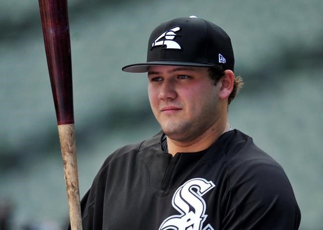 FILE - In this June 26, 2017, file photo, Chicago White Sox's Jake Burger watches during batting practice before the team's baseball game against the New York Yankees in Chicago. Burger is going to play in a local league this summer in his hometown of St. Louis after the White Sox approved the plan for their first-round pick in the 2017 amateur draft. The cancellation of this year's minor league season put prospects like Burger in a tough spot without anywhere to go for game action that could help continue their development. (AP Photo/Paul Beaty, File)