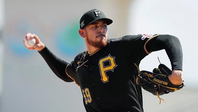 FILE - Pittsburgh Pirates starting pitcher Joe Musgrove plays during a spring training baseball game, Thursday, March 12, 2020, in Bradenton, Fla. Musgrove doesn't like wearing a mask more than any of his Pittsburgh Pirate teammates. Yet the pitcher wore one anyway during the first day of workouts on Friday, just one way he is trying to lead a pitching staff searching for an ace with Jameson Taillon and Chris Archer already out for 2020. (AP Photo/Carlos Osorio)