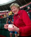 FILE - In this Sept. 22, 2002 file photo former Cincinnati Reds majority owner Marge Schott signs autographs prior to the final game at Cinergy Field in Cincinnati. Schott was a divisive figure when she owned the Cincinnati Reds, getting suspended and ultimately forced out for her racially offensive language. The community is debating what to do with facilities named in her memory. (AP Photo/David Kohl, file)