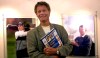 FILE - In this Aug. 21, 2003 file photo Alastair Johnston, vice chairman of IMG, poses outside his office with one of his books in Cleveland. Johnston has the largest collection of golf books in the world, and he' s gifting it to the R&A. (AP Photo/Jamie-Andrea Yanak, file)