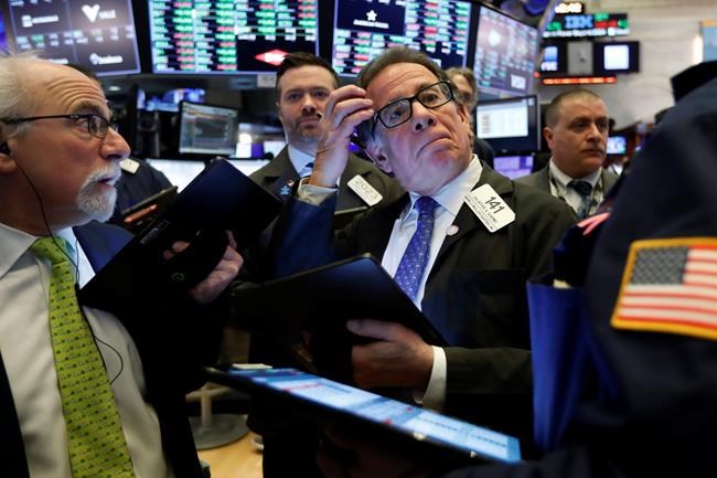 Sal Suarino, center, works with fellow traders on the floor of the New York Stock Exchange, Tuesday, March 10, 2020. Stocks, Treasury yields and oil are clawing back some of the plunge they took a day before, when the S&P 500 had its worst drop in more than a decade. (AP Photo/Richard Drew)