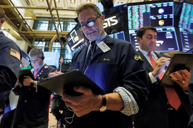 Trader Ronald Madarasz, center, works on the floor of the New York Stock Exchange, Tuesday, March 10, 2020. Stocks, Treasury yields and oil are clawing back some of the plunge they took a day before, when the S&P 500 had its worst drop in more than a decade. (AP Photo/Richard Drew)