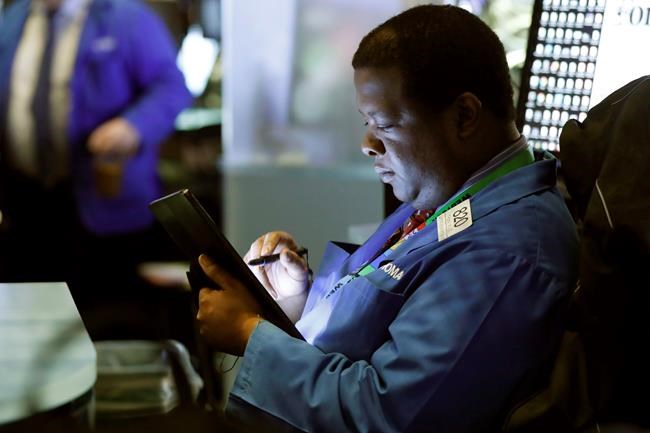 Trader Thomas Lee works on the floor of the New York Stock Exchange, Tuesday, March 10, 2020. T=Stocks, Treasury yields and oil are clawing back some of the plunge they took a day before, when the S&P 500 had its worst drop in more than a decade. (AP Photo/Richard Drew)