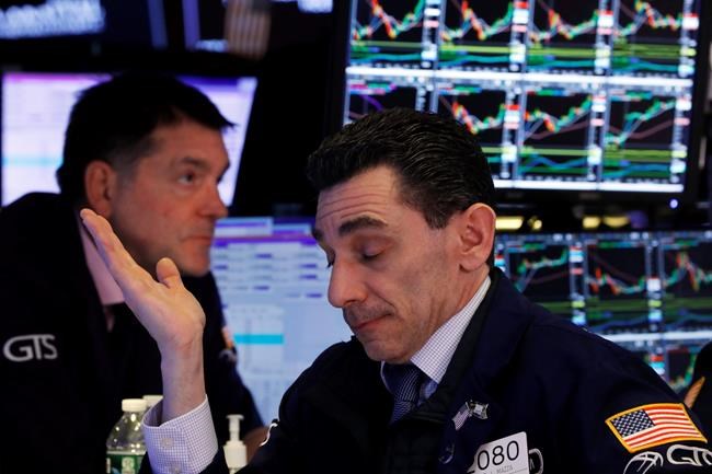 Specialists Peter Mazza, right, and David Haubner work on the floor of the New York Stock Exchange, Tuesday, March 10, 2020. Stocks are struggling higher on Wall Street Tuesday as trading takes another volatile turn. The market surged in the early going, fell into the red by lunchtime and was modestly higher in the afternoon. (AP Photo/Richard Drew)