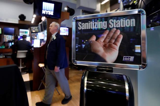 A trader passes a hand sanitizing station on the floor of the New York Stock Exchange, Tuesday, March 3, 2020. Federal Reserve Chairman Jerome Powell noted that the coronavirus