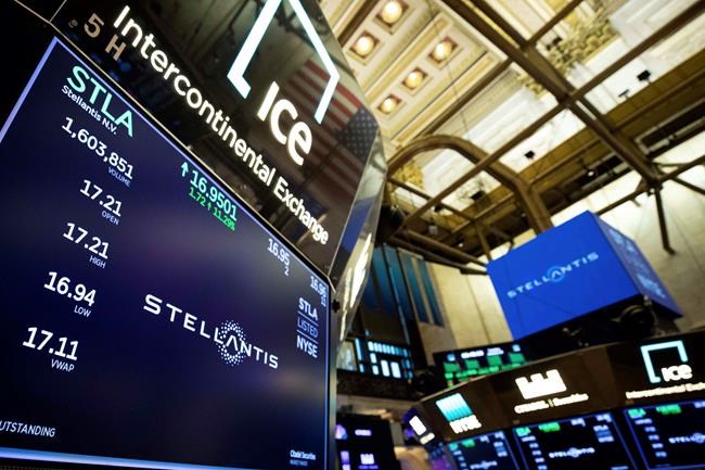In this photo provided by the New York Stock Exchange, the logo for Stellantis appears above a post on the trading floor, Tuesday, Jan. 19. 2021. Shares start trading in New York in the new auto giant created by the merger of Fiat Chrysler and PSA Peugeot. (Colin Ziemer/New York Stock Exchange via AP)