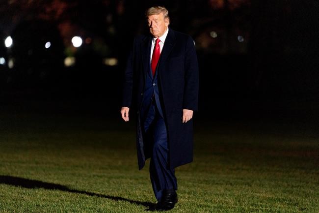 FILE - In this Tuesday, Jan. 5, 2021, file photo, President Donald Trump arrives in the early morning hours at the White House in Washington, after returning from a rally in Dalton, Ga. Trump’s days in office are numbered. But he’s already stopped doing much of his job. (AP Photo/Andrew Harnik, File)