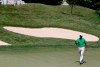 FILE - In this Saturday, June 30, 2012, file photo, Tiger Woods walks off the first green after making birdie during the third round of the AT&T National golf tournament at Congressional Country Club in Bethesda, Md. As of April 2020, Woods has won the last two PGA Tour events when spectators were not allowed during one round of the tournament. (AP Photo/Patrick Semansky, File)